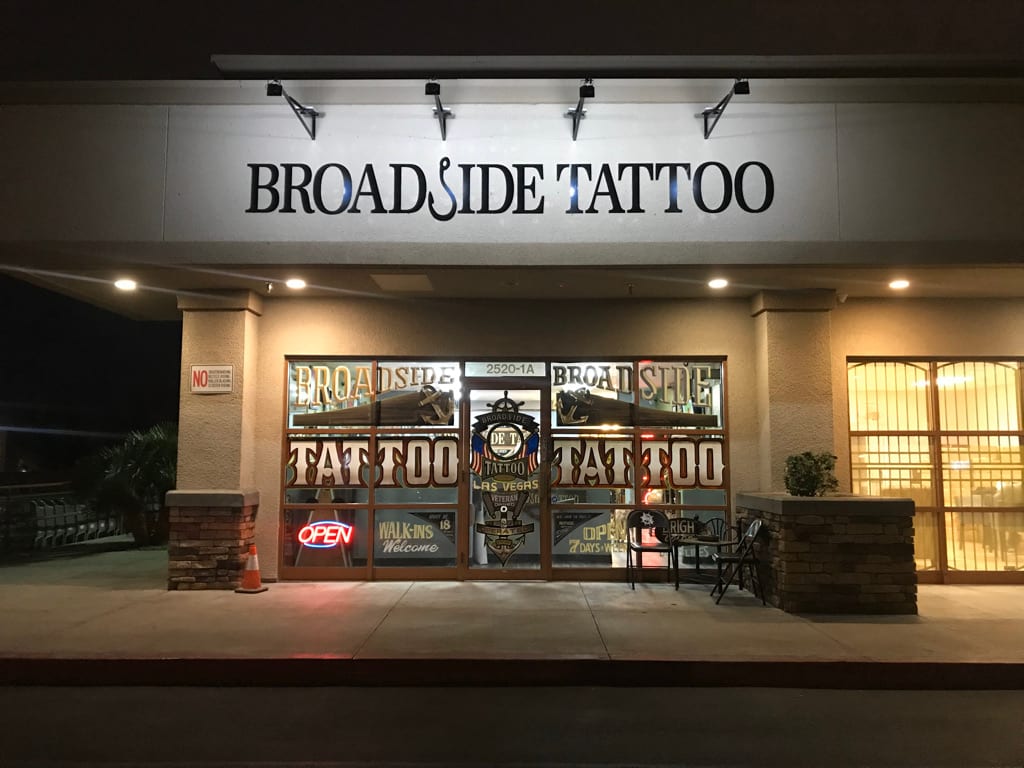 lit storefront sign las vegas Broadside Tattoo storefront sign and lit window graphics at night