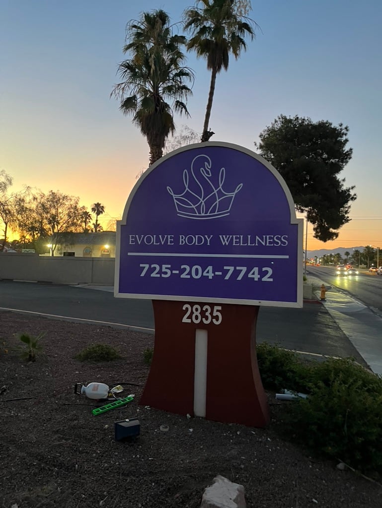 monument sign Evolve Body Wellness monument sign at dusk
