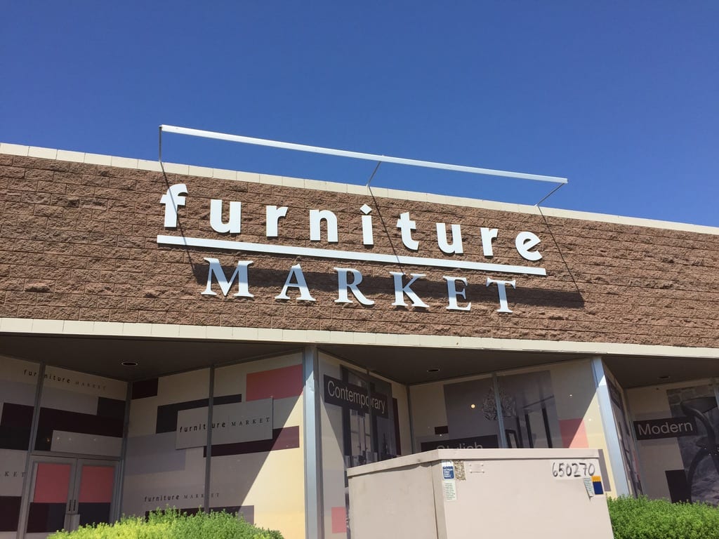 exterior building letters las vegas Furniture Market exterior building sign: white dimensional letters on a block wall above the storefront