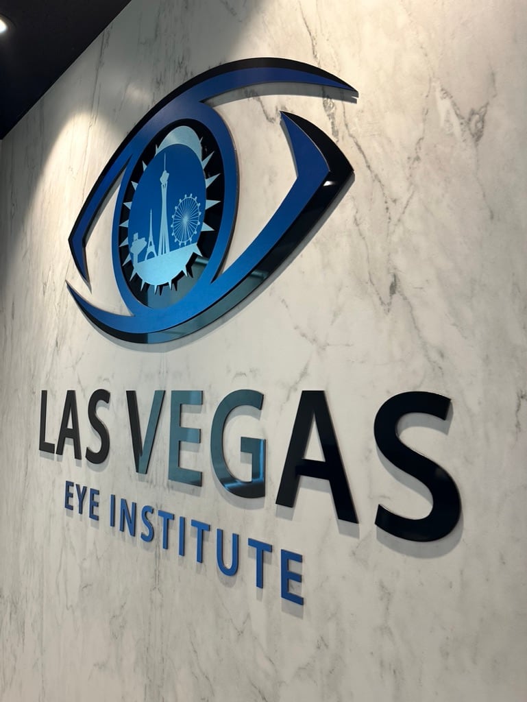3d lobby logo sign Las Vegas Eye Institute lobby sign with a 3D eye logo on a marble wall