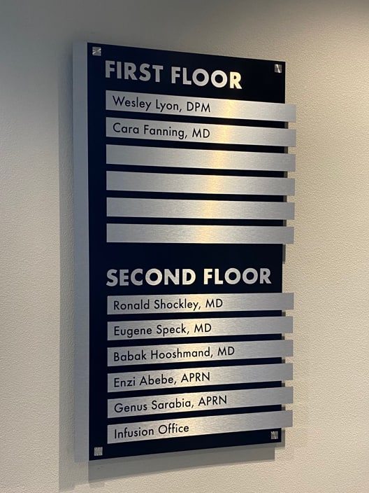 lobby directory sign brushed aluminum Lobby directory sign: first and second floor tenant names on brushed aluminum strips over a black panel