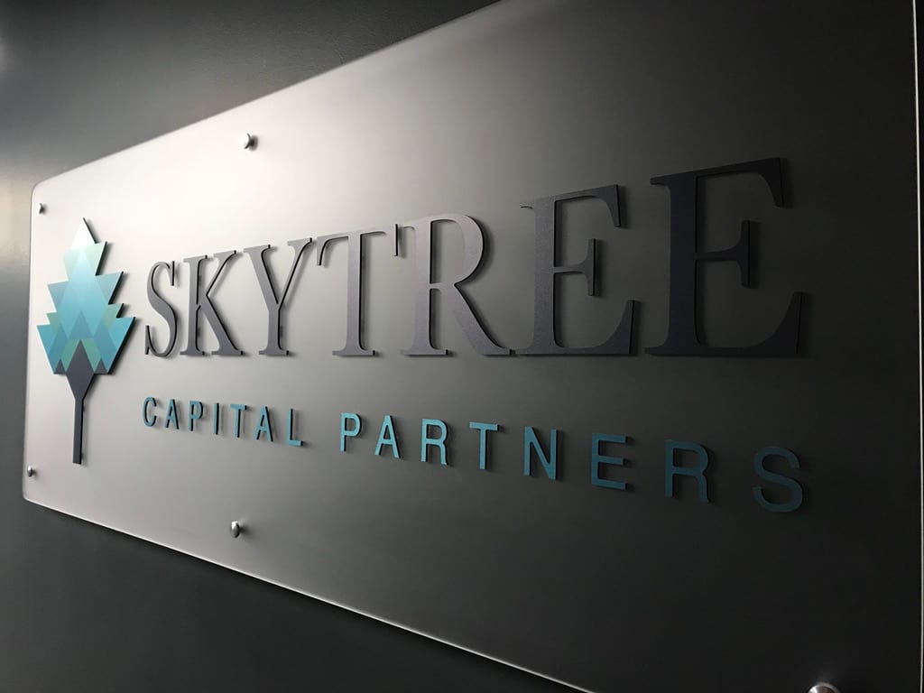 acrylic lobby sign las vegas Skytree Capital Partners lobby sign: dimensional letters and logo on a frosted acrylic panel with standoffs