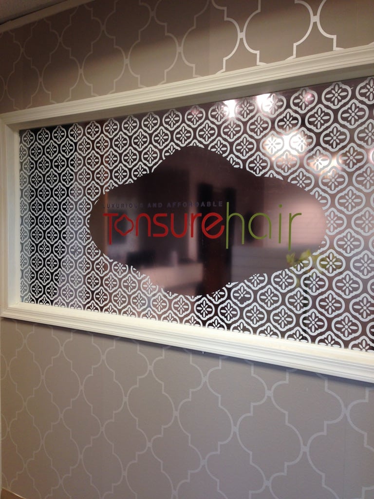 frosted privacy window film Tonsure Hair interior window with a patterned frosted privacy film and logo