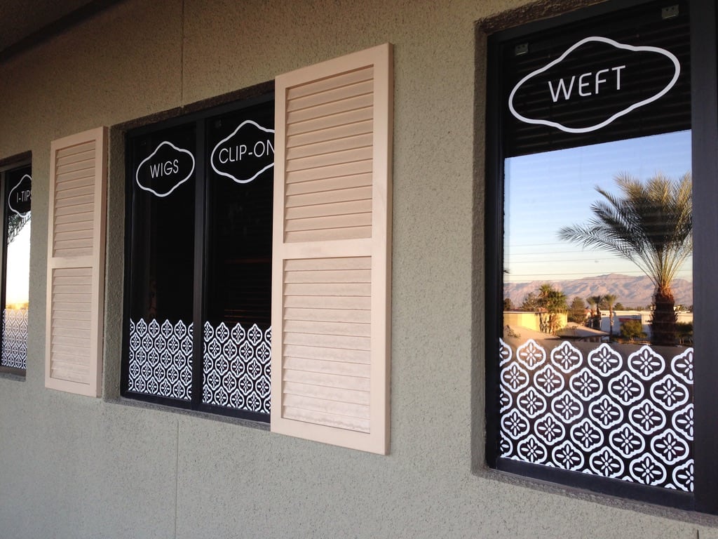 window graphics and decorative film Tonsure Hair window graphics: Wigs, Clip-ons and Weft labels over a decorative window film
