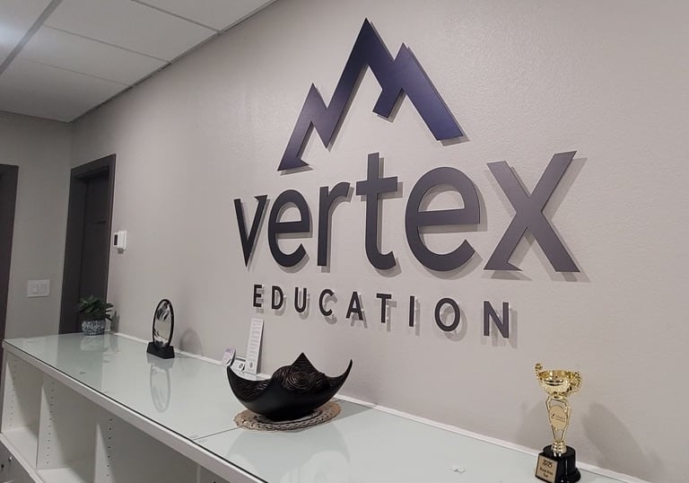 3d lobby sign Vertex Education 3D lobby sign on a reception wall